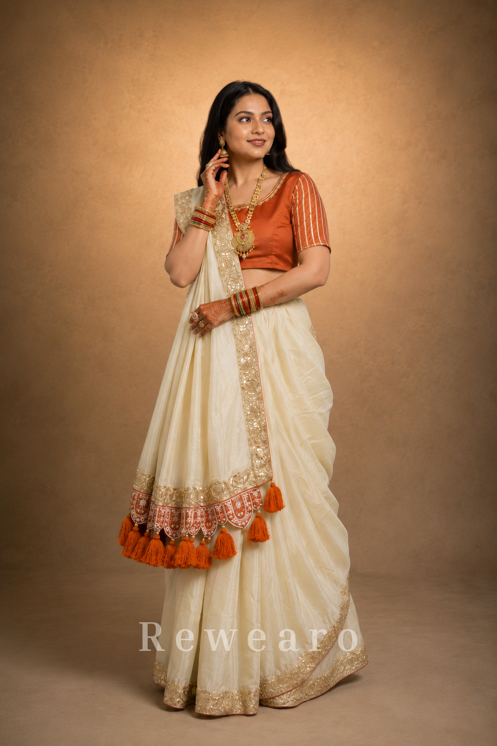 Ivory Draped Saree with Rust Embroidered Blouse and Tassel Border Pallu
