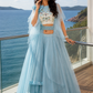 Powder Blue Layered Ruffle Lehenga Set with Printed Blouse and Dramatic Cape Sleeves