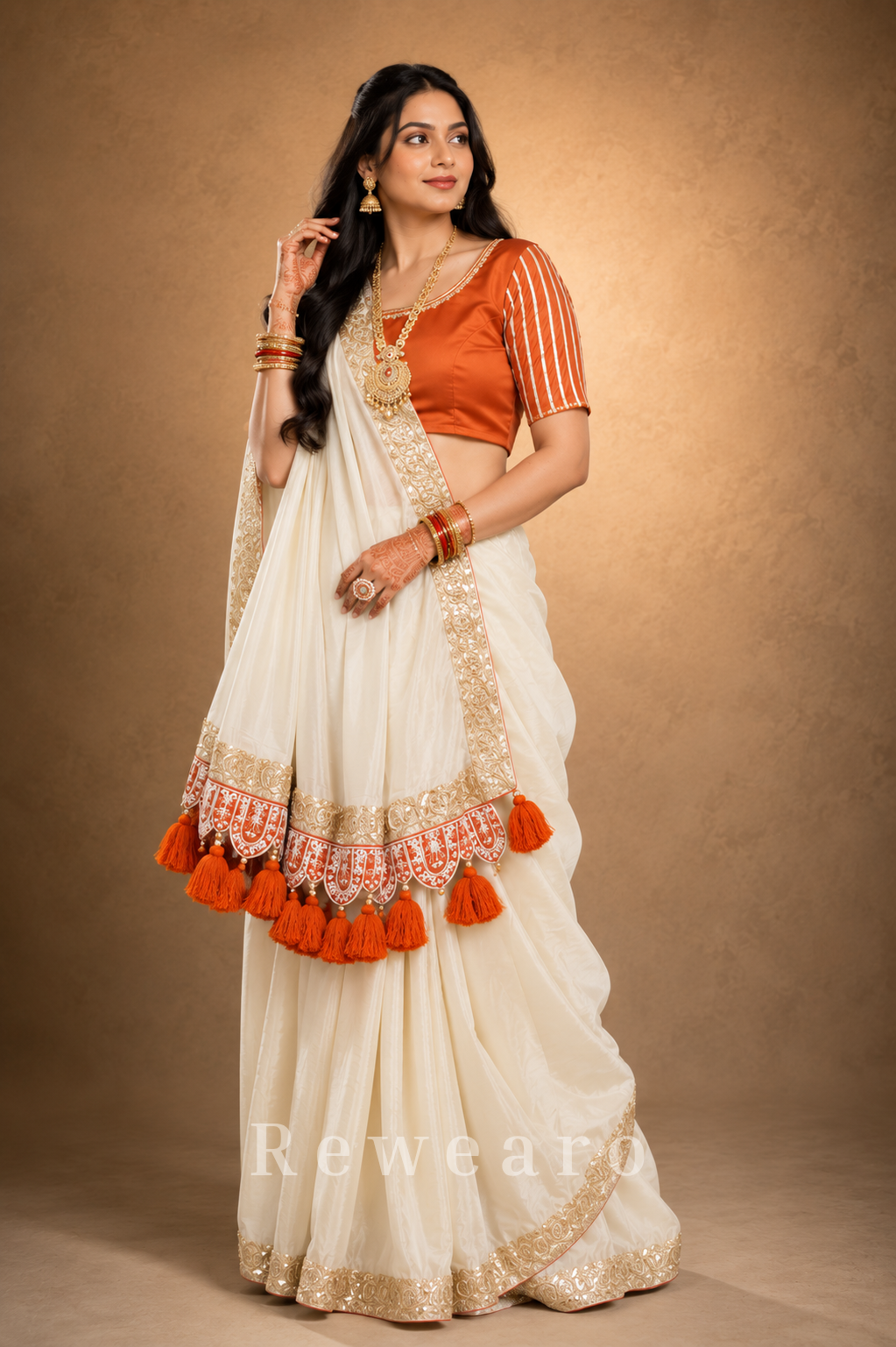 Ivory Draped Saree with Rust Embroidered Blouse and Tassel Border Pallu