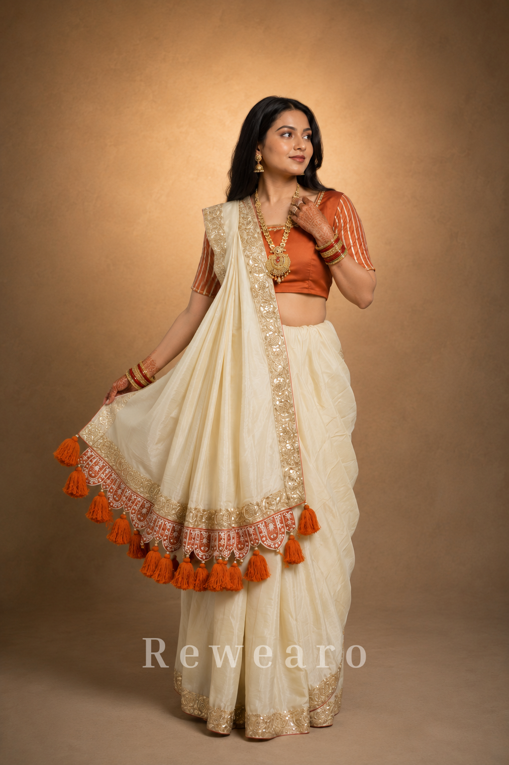 Ivory Draped Saree with Rust Embroidered Blouse and Tassel Border Pallu