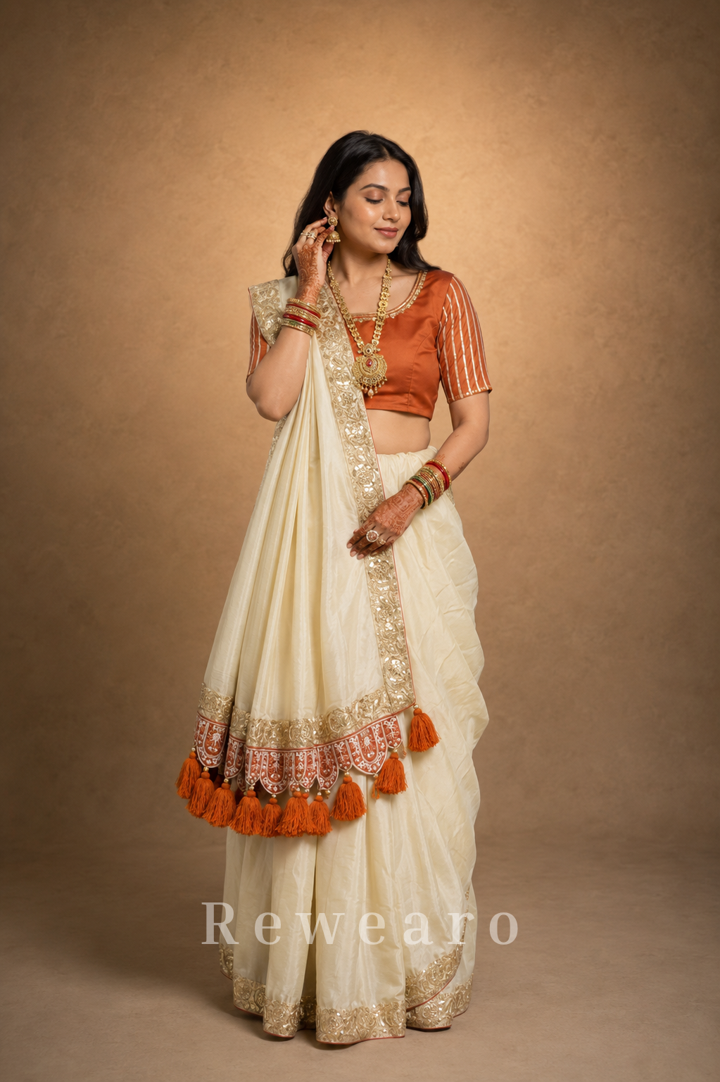 Ivory Draped Saree with Rust Embroidered Blouse and Tassel Border Pallu