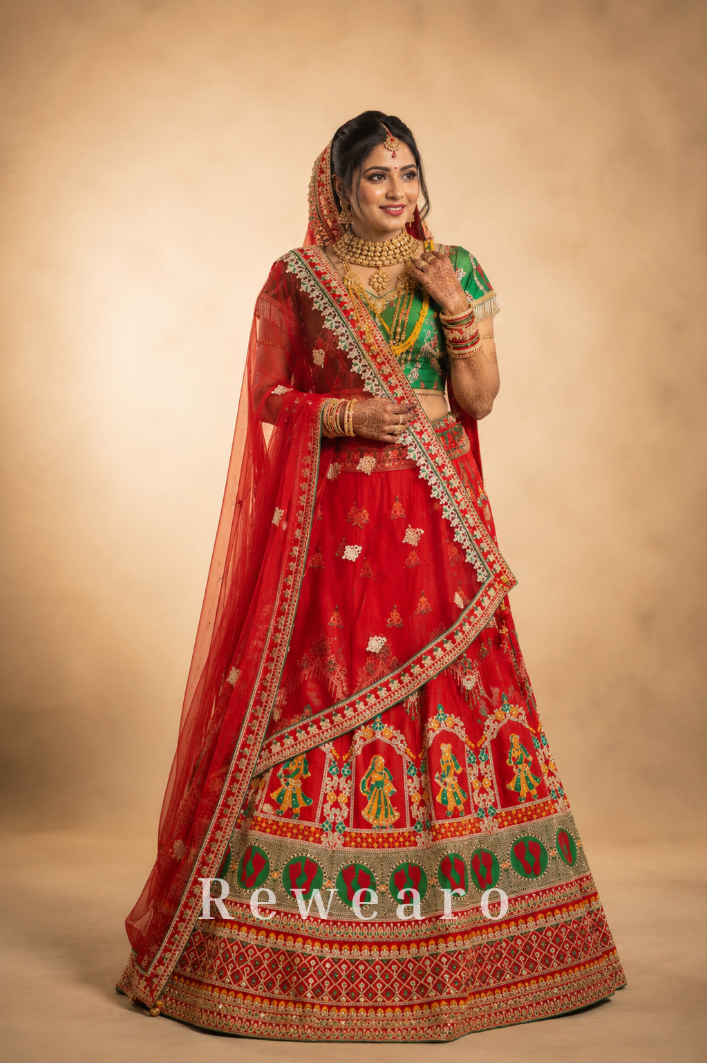 Crimson Bridal Lehenga with Folk-Figurative Border, Emerald Brocade Blouse & Ornate Veil